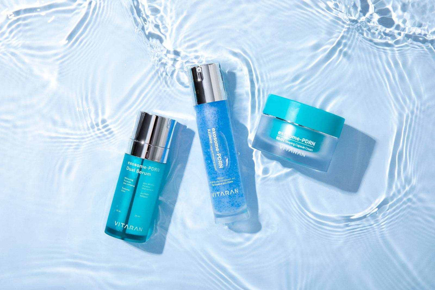 VITARAN Three Step Daily Salmon DNA Skin Healing Bundle with serums and cream on a water surface.