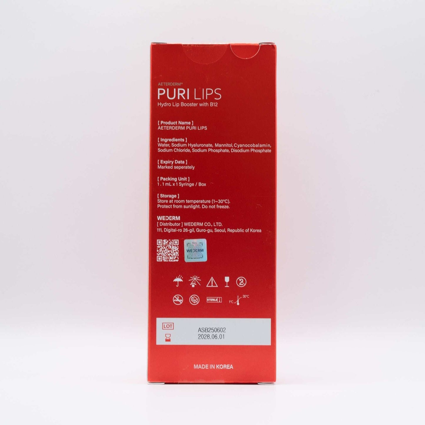 Red packaging of Puri Lips Hydro Lip Booster with B12, featuring product details and storage instructions on the back.