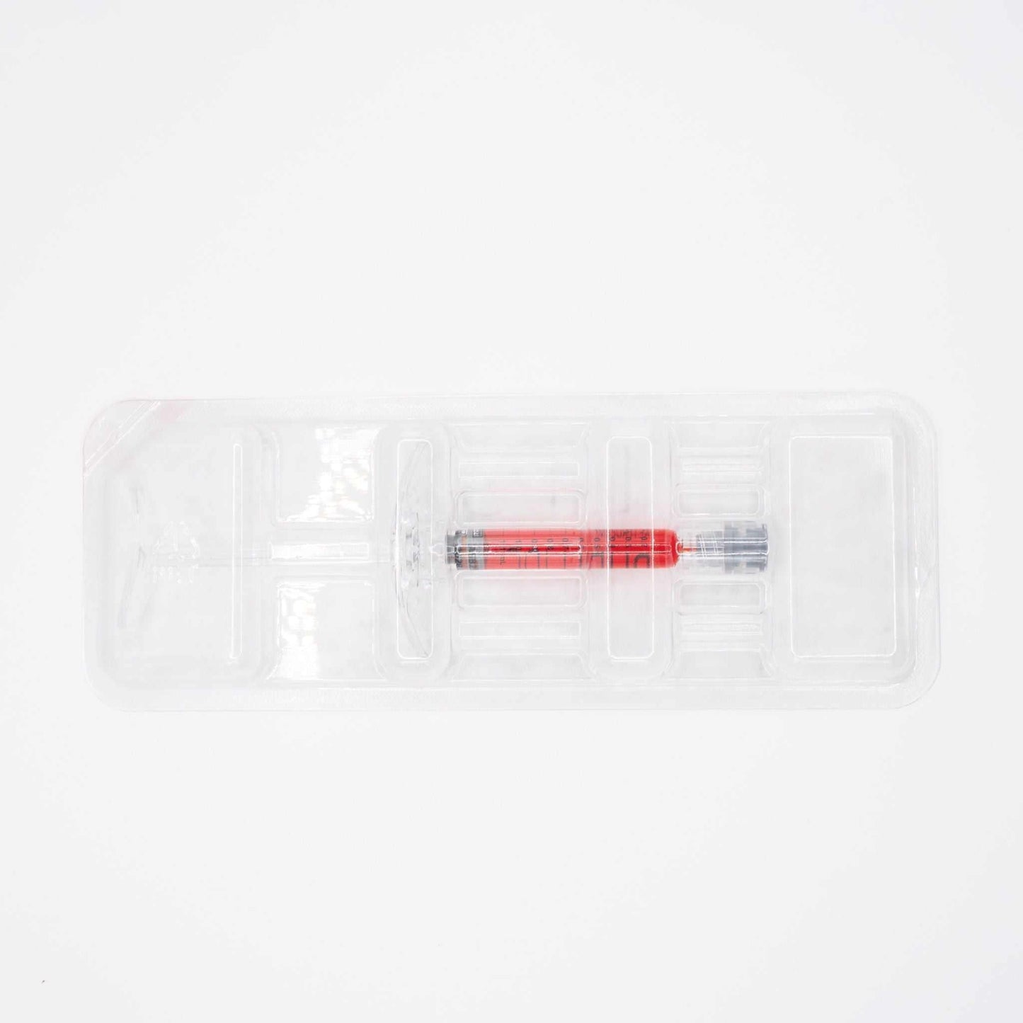 Puri Lips Hydro Lip Booster syringe with scarlet vitamin B12 tint for hydrating and plumping lips.