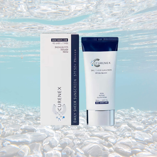 Curenex Salmon DNA Sheer Sunscreen SPF50+ PA++++ in 50ml tube and box against a watery backdrop.