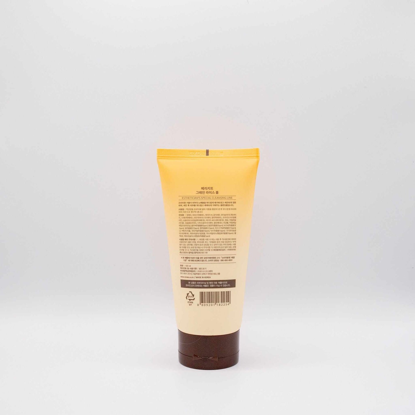 Merikit Grain Rice Korean foam cleanser tube with yellow and brown packaging shown from the back against a plain white background